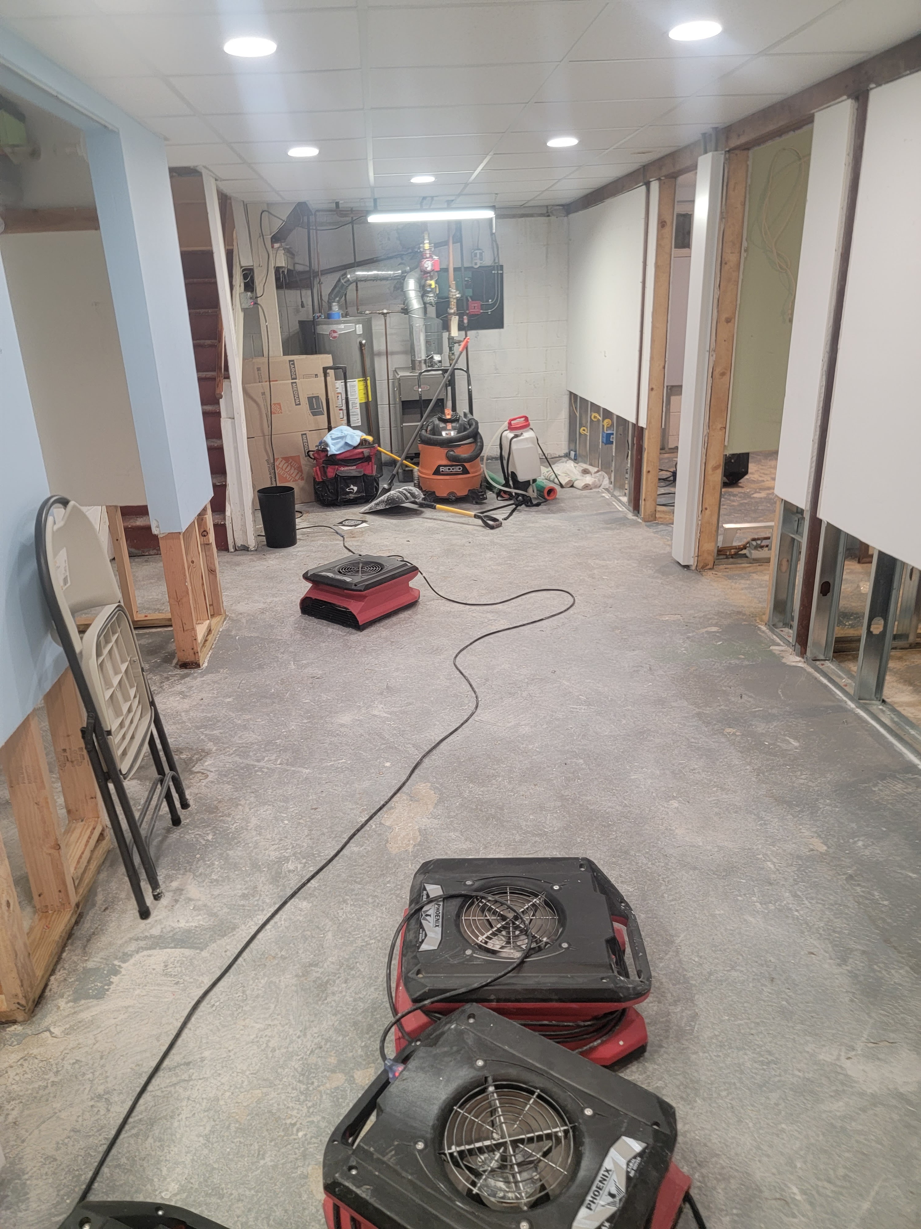 Basement flooding cleanup and structural drying in progress after a storm event
