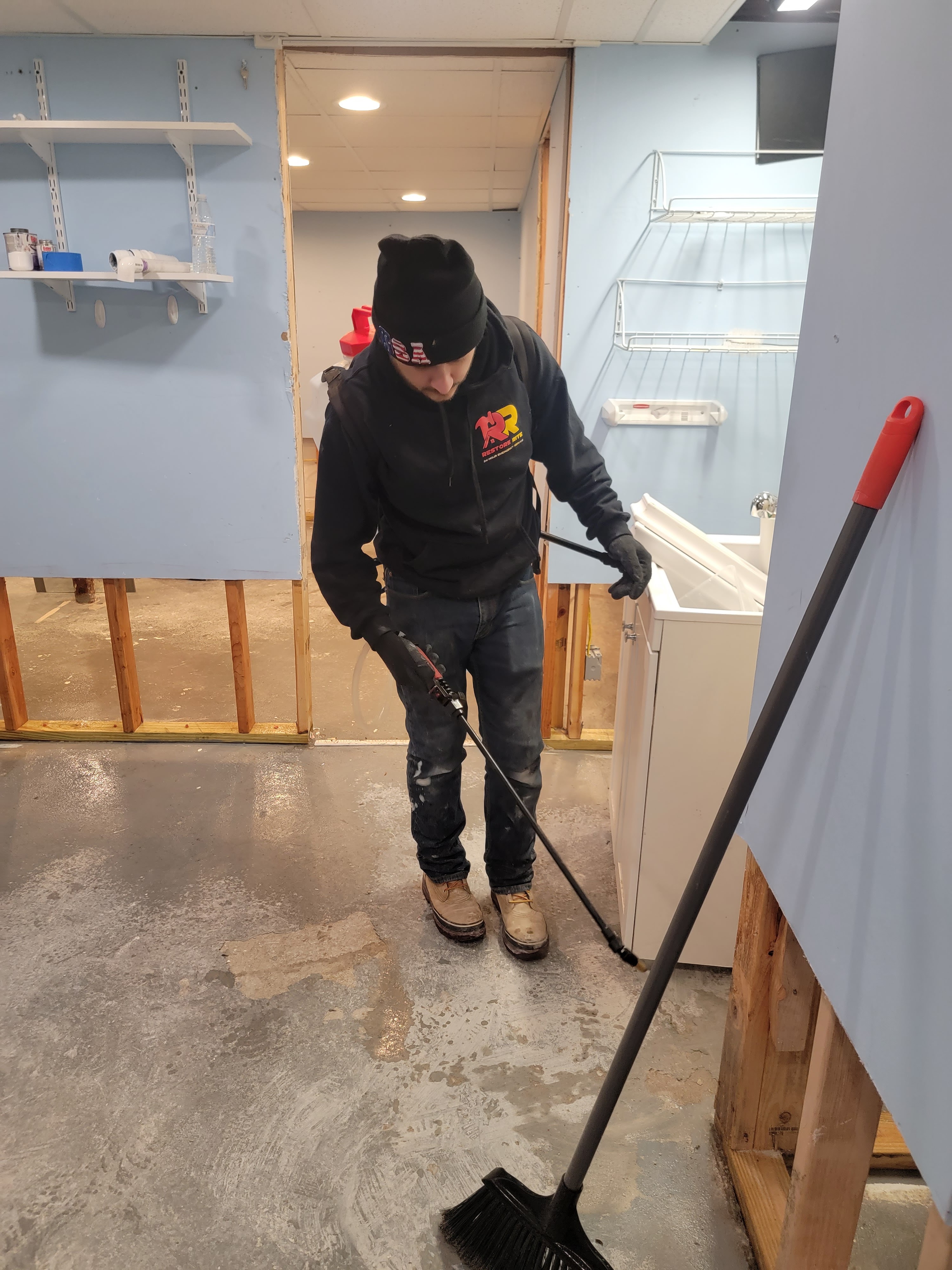 Restore Rite technician applying treatment during post-mitigation reconstruction at a Tri-State job site