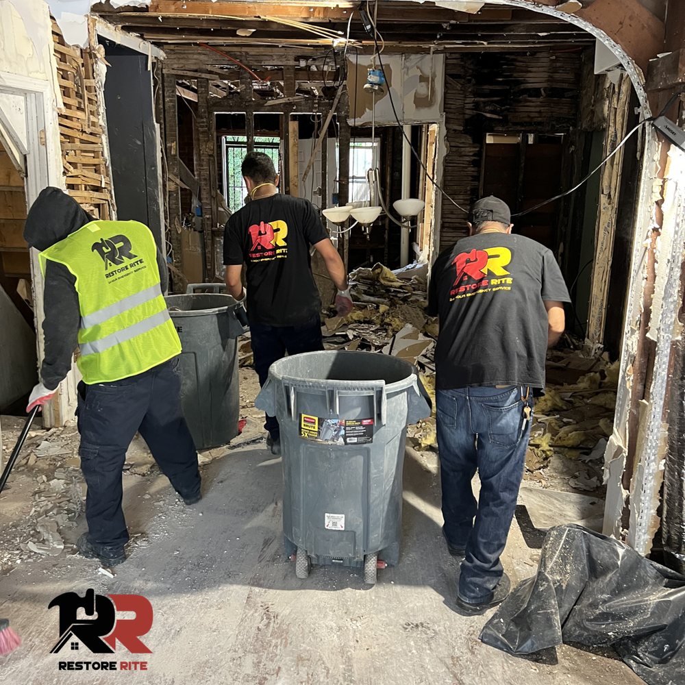 Restore Rite crew clearing debris from fire-damaged interior