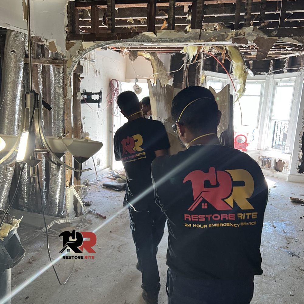 Restore Rite technicians walking through a damaged property