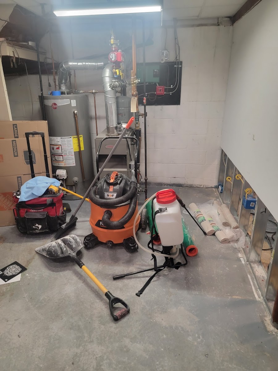 Water damage job site — industrial air movers staged across a flooded room during remediation